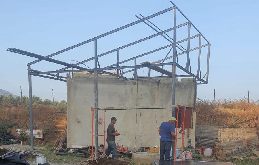 Structure métallique solaire en cours d'installation près d'un bassin